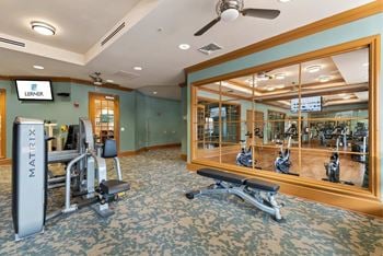 Newly remodeled fitness center with aerobics room featuring wellbeats virtual fitness class program